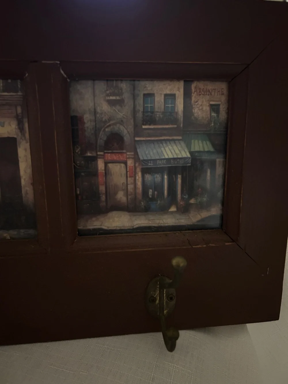 Wall-Mount Coat Rack with Brown Frame and Vintage Artwork